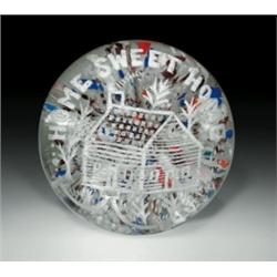 Antique Millville frit paperweight, with a depiction of a log cabin and trees, framed by the ins...