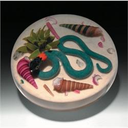 Gordon Smith snake and seashell paperweight, containing a blue water snake, with a black head an...
