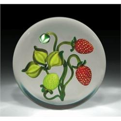 Gordon Smith strawberry paperweight, with two red strawberries and one green berry on curved ste...