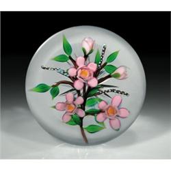 Debbie Tarsitano floral paperweight, with a marbled brown branch containing three upright pink b...