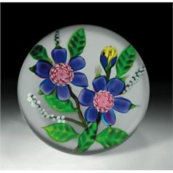 Debbie Tarsitano floral bouquet paperweight, containing two large purple flowers, each having a...