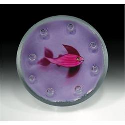 Paul Ysart pink fish paperweight, with a fish, having translucent dark pink tail and fins, swimm...