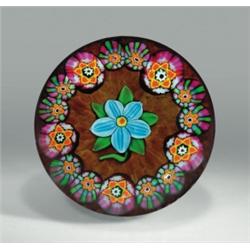 Paul Ysart early floral paperweight, containing a central blue flower with green leaves, encircle...