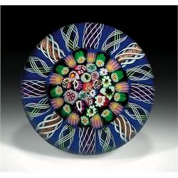 Paul Ysart patterned millefiori paperweight, with a central cluster of close packed canes, which...