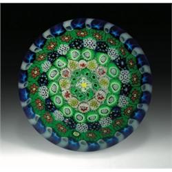 Drew Ebelhare concentric millefiori paperweight, with a small central white rose, encircled by c...