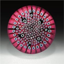 Whitefriars close packed millefiori paperweight, with canes in pink, black, and white, some with...