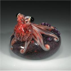 Orient & Flume rock relief paperweight, with a three-dimensional orange octopus clinging to a spe...