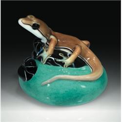 Orient & Flume rock relief paperweight, with a three-dimensional greenish-brown lizard, resting...