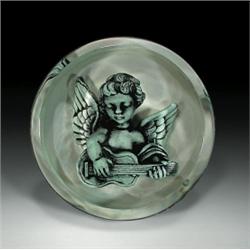 Andrew Fote magnum cherub paperweight, with a sculpture of a gray and black cherub playing a gui...