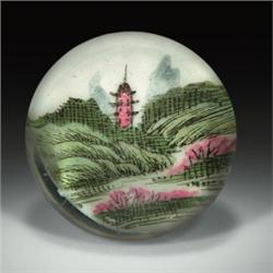 Chinese painted landscape paperweight, depicting a pagoda and rolling green hills, with pink flow...