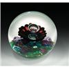 Image 1 : Selkirk Glass "Corona" abstract design paperweight, with a central bubble over a dark red flower...