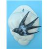 Image 1 : A Clarice Cliff slip-moulded wall pocket, with applied swallow against an off-white background, p...