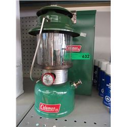 Used Coleman lantern with metal case.
