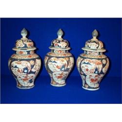 A SUITE OF THREE CHINESE IMARI BALUSTER SHAPED VASES AND COVERS, 19th CENTURY, the domed lids wit...