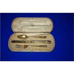 A GILT CHRISTENING SET, LONDON 1917, consisting of a knife, fork and spoon, engraved with a monog...