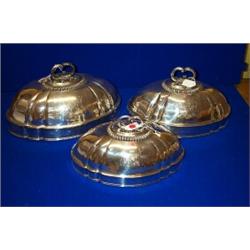 A SET OF THREE Plated OVAL MEAT DISH COVERS, retailed by Garrards, London, with leaf decorated ha...