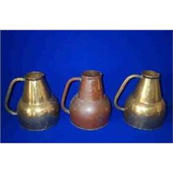 THREE BRASS HOT WATER SERVING JUGS, 19th CENTURY, with pouring lips and hollow handles, 23cms h...