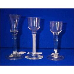 A PLAIN HEAVY OGEE BOWLED CORDIAL GLASS, c.1760 PROBABLY NEWCASTLE, 14cms high; a waisted small b...