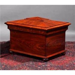 A MAHOGANY SARCOPHAGUS SHAPED CELLARET, MID 19th CENTURY, with heavy moulded lid, plain sides, th...