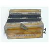 Image 1 : AN OAK ACCORDION, early 20th Century, paper bellows, ten buttons, length 28cm  £30-40...