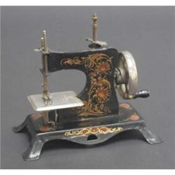 Early 20th century German child's sewing machine, transfer printed with stylised chrysanthemum in...