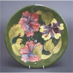 Walter Moorcroft plaque, tube lined with colourful amarylis on a dark green ground, painted WM si...