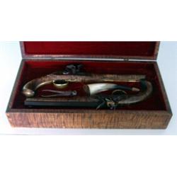 Contemporary cased pair of flint locks. Curly maple stocks and box. Bullet mold and powder horn....