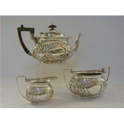 A THREE PIECE BOMBE TEA SERVICE, Art Nouveau chased design, maker Dixons, Sheffield 1904, (approx...