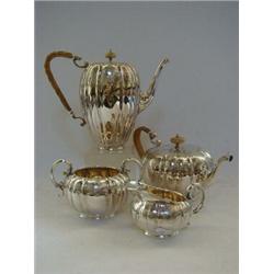 AN ELKINGTONS FOUR PIECE PLATED TEA SERVICE, c.1880, melon fluted and bright cut engraved, wicker...