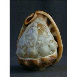 A CAMEO CARVED CONCH SHELL, first half of the 20th Century, classically draped maiden making musi...