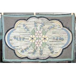 FLORAL HOOKED RUG.