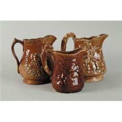 THREE ROCKINGHAM WARE PITCHERS.