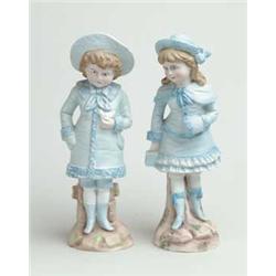 PAIR OF BISQUE DECORATED FIGURINES.