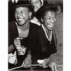 WEEGEE (ARTHUR FEELIG), (American, 1899-1968), AT A CONCERT IN HARLEM, stamped "Credit photo by W...