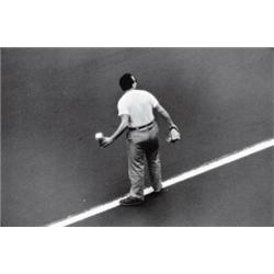 W. EUGENE SMITH, (American, 1918- 1978), UNTITLED (MAN CROSSING STREET), stamped "Photograph by W...