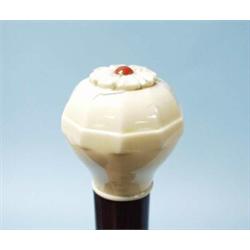 An Art Deco walking stick with a cabochon coral mounted ivory bun handle and thumble tip. 37 1/2"…