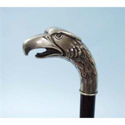 An unusual antique German bamboo walking stick with handle in form of a repousse worked silver ea…