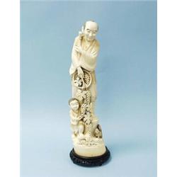 A large antique Japanese carved ivory group of peasants gathering grapes. Signed underside. 19 1/…