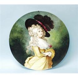 An antique French porcelain wallplate. Handpainted with the portrait of a young lady with a large…