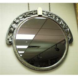 ART DECO - A French circular bevelled glass wall mirror in wrought iron frame. The circular frame…
