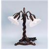 Image 1 : ART NOUVEAU - A fine multipatinated wrought iron table lamp with frosted art glass tulip form sha…
