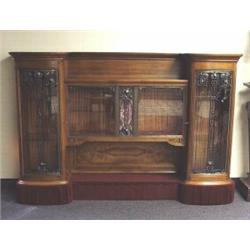ART NOUVEAU - LOUIS MAJORELLE. A fine mahogany and fruitwood book case. The central vitrine doors…
