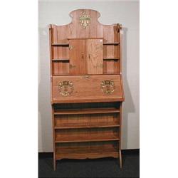VIENNA SECESSION - A lady's drop front desk. The brass mounted oak etagere fitted with a fold up …