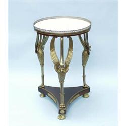 An antique French Empire style mahogany and bronze tripod table. The circular white marble top wi…