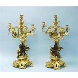 A pair of fine antique French gilt bronze candelabra. The cartouche base with five scroll armed f…