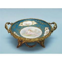 An antique French Sevres porcelain centrepiece with gilt bronze mounts. Central medallion hand pa…
