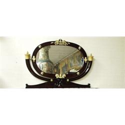 An antique French Napoleon III mahogany framed over-mantle mirror. The oval glass in a bull horn …