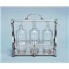 Image 1 : ART DECO - A silver plated tantalus by Christofle. Fitted with three glass decanters and matching…