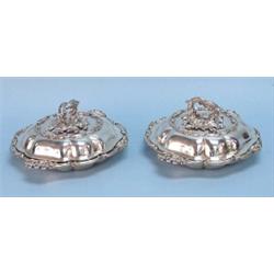 A fine pair of antique English sterling silver covered vegetable dishes by John Samuel Hunt. Each…