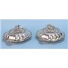 A fine pair of antique English sterling silver covered vegetable dishes by John Samuel Hunt. Each…